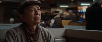 Movie still from “The Day the Earth Stood Still” (2008), directed by Scott Derrickson – An older man sitting in front of a group of people; Close Up shot, Over the shoulder angle
