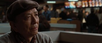 Movie still from “The Day the Earth Stood Still” (2008), directed by Scott Derrickson – An older man wearing a hat and looking off to his left; Close Up shot, Over the shoulder angle