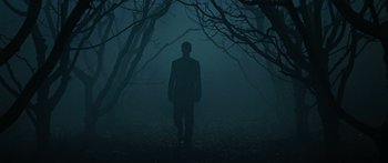 Movie still from “The Day the Earth Stood Still” (2008), directed by Scott Derrickson – A man standing in the middle of a forest; Wide shot, Low angle