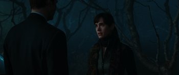 Movie still from “The Day the Earth Stood Still” (2008), directed by Scott Derrickson – A woman standing next to a man in a dark forest; Close Up shot, Over the shoulder angle