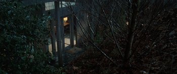 Movie still from “The Day the Earth Stood Still” (2008), directed by Scott Derrickson – A building in the middle of a forest at night; Wide shot, High angle