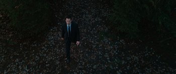 Movie still from “The Day the Earth Stood Still” (2008), directed by Scott Derrickson – A man in a suit and tie walking in the leaves; Extreme Wide shot, High angle