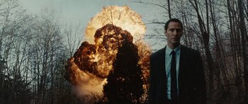 Movie still from “The Day the Earth Stood Still” (2008), directed by Scott Derrickson – A man standing in front of an exploding tree; Medium shot, Low angle