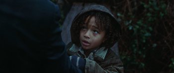 Movie still from “The Day the Earth Stood Still” (2008), directed by Scott Derrickson – A young boy wearing a hooded jacket and a scarf; Close Up shot, High angle