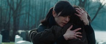 Movie still from “The Day the Earth Stood Still” (2008), directed by Scott Derrickson – A woman is hugging another woman in a forest; Close Up shot, Over the shoulder angle