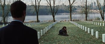 Movie still from “The Day the Earth Stood Still” (2008), directed by Scott Derrickson – A woman kneeling down in front of a row of white tombstones; Extreme Wide shot, Over the shoulder angle