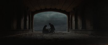 Movie still from “The Day the Earth Stood Still” (2008), directed by Scott Derrickson – A man and a woman sitting under an arch; Extreme Wide shot, Low angle