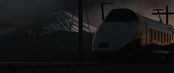 Movie still from “The Day the Earth Stood Still” (2008), directed by Scott Derrickson – A train traveling down train tracks next to a mountain; Extreme Wide shot, Low angle