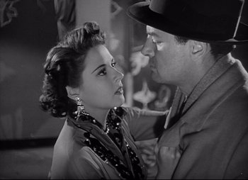 Movie still from “City That Never Sleeps” (1953), directed by John H. Auer – A man and a woman are looking into each others eyes; Close Up shot, Low angle