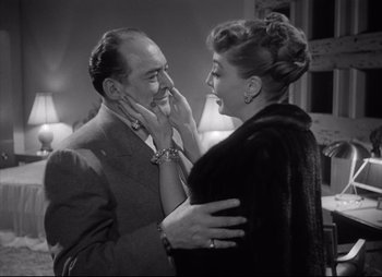 Movie still from “City That Never Sleeps” (1953), directed by John H. Auer – A man and a woman are smiling at each other; Close Up shot, Low angle