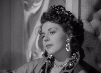 Movie still from “City That Never Sleeps” (1953), directed by John H. Auer – An old photo of a woman in a dress; Close Up shot, Low angle