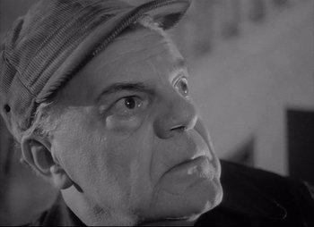 Movie still from “City That Never Sleeps” (1953), directed by John H. Auer – An older man wearing a hat looking to his left; Close Up shot, Low angle