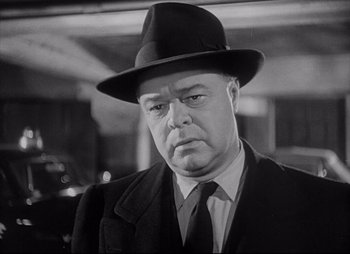 Movie still from “City That Never Sleeps” (1953), directed by John H. Auer – An older man in a suit and a hat; Close Up shot, Low angle