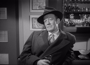 Movie still from “City That Never Sleeps” (1953), directed by John H. Auer – An older man wearing a suit and a hat holding a glass; Medium shot, High angle