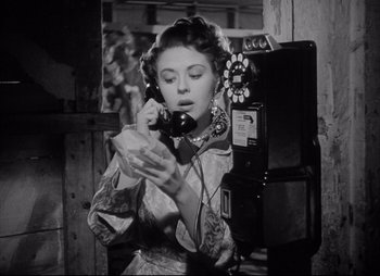Movie still from “City That Never Sleeps” (1953), directed by John H. Auer – An old photo of a woman talking on a phone; Close Up shot, Low angle