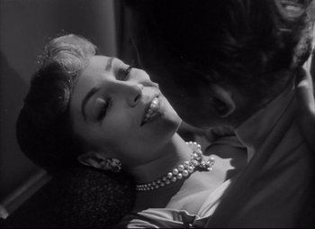 Movie still from “City That Never Sleeps” (1953), directed by John H. Auer – A man and a woman are kissing on the forehead; Close Up shot, Low angle