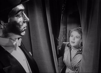 Movie still from “City That Never Sleeps” (1953), directed by John H. Auer – A man and a woman are looking at each other in a mirror; Close Up shot, Low angle