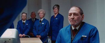 Movie still from “City of Ember” (2008), directed by Gil Kenan – A group of people standing around a table; Medium shot, Over the shoulder angle