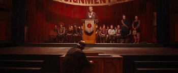 Movie still from “City of Ember” (2008), directed by Gil Kenan – A man is standing in front of an audience; Wide shot, High angle