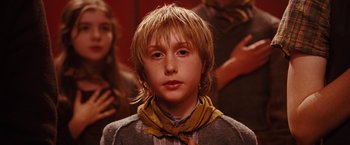 Movie still from “City of Ember” (2008), directed by Gil Kenan – A young boy with long blonde hair wearing a neck tie; Close Up shot, Over the shoulder angle