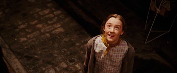 Movie still from “City of Ember” (2008), directed by Gil Kenan – A young girl standing in front of a brick wall; Medium shot, High angle