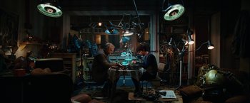 Movie still from “City of Ember” (2008), directed by Gil Kenan – Two people sitting at a table in a room; Wide shot, High angle