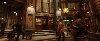Movie still from “City of Ember” (2008), directed by Gil Kenan – A couple of people walking down a street; Wide shot, Low angle