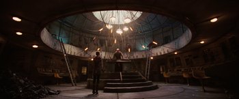 Movie still from “City of Ember” (2008), directed by Gil Kenan – Two people standing in a room with lights hanging from the ceiling; Extreme Wide shot, Low angle