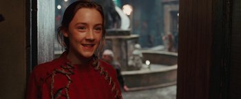Movie still from “City of Ember” (2008), directed by Gil Kenan – A young girl in a red sweater smiling for the camera; Close Up shot, Over the shoulder angle
