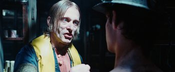 Movie still from “City of Ember” (2008), directed by Gil Kenan – A man in a yellow and red shirt is looking at another man in a blue shirt; Close Up shot, Over the shoulder angle