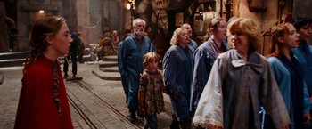 Movie still from “City of Ember” (2008), directed by Gil Kenan – A group of people walking down a street; Wide shot, High angle