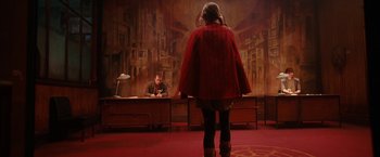 Movie still from “City of Ember” (2008), directed by Gil Kenan – A man and a woman are standing in front of a painting; Wide shot, Over the shoulder angle