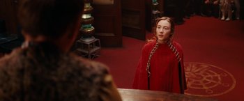 Movie still from “City of Ember” (2008), directed by Gil Kenan – A young woman in a red dress looking in a mirror; Medium shot, Over the shoulder angle