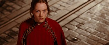 Movie still from “City of Ember” (2008), directed by Gil Kenan – A woman in a red cape standing in front of a computer keyboard; Close Up shot, High angle
