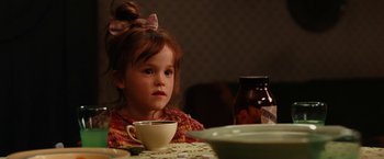 Movie still from “City of Ember” (2008), directed by Gil Kenan – A little girl sitting at a table with a cup of coffee; Close Up shot, Over the shoulder angle
