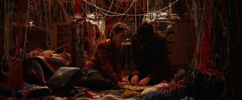 Movie still from “City of Ember” (2008), directed by Gil Kenan – Two women sitting on the floor in front of a bunch of yarn; Medium shot, Overhead angle