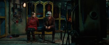 Movie still from “City of Ember” (2008), directed by Gil Kenan – A man and a woman sitting next to each other on a bench; Medium shot, Low angle