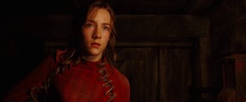 Movie still from “City of Ember” (2008), directed by Gil Kenan – A woman in a red dress standing next to a wooden wall; Close Up shot, Low angle