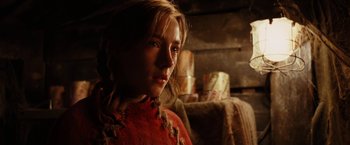 Movie still from “City of Ember” (2008), directed by Gil Kenan – A young woman in a red dress is looking at the camera; Close Up shot, Over the shoulder angle