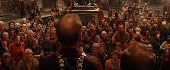 Movie still from “City of Ember” (2008), directed by Gil Kenan – A group of people standing around a statue of a man; Wide shot, High angle