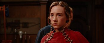 Movie still from “City of Ember” (2008), directed by Gil Kenan – A young girl in a red dress looking into the camera; Close Up shot, Over the shoulder angle