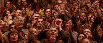 Movie still from “City of Ember” (2008), directed by Gil Kenan – A group of people sitting in a crowd clapping; Medium shot, High angle