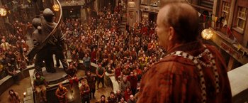 Movie still from “City of Ember” (2008), directed by Gil Kenan – A large crowd of people are gathered around a man; Extreme Wide shot, High angle