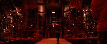 Movie still from “City of Ember” (2008), directed by Gil Kenan – A man walking down a hallway in an industrial setting; Extreme Wide shot, Low angle