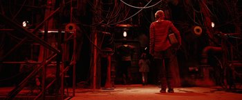 Movie still from “City of Ember” (2008), directed by Gil Kenan – A man standing in a room with wires hanging from the ceiling; Wide shot, Low angle