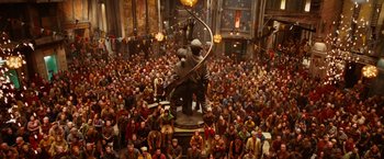 Movie still from “City of Ember” (2008), directed by Gil Kenan – A crowd of people sitting in front of a statue; Wide shot, High angle