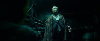 Movie still from “City of Ember” (2008), directed by Gil Kenan – An older man wearing a long green cape; Medium shot, Low angle