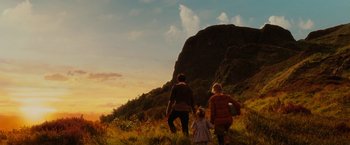 Movie still from “City of Ember” (2008), directed by Gil Kenan – Two women and a child are standing in a field; Extreme Wide shot, Low angle