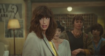 Movie still from “City of Women” (1980), directed by Federico Fellini – A woman in a white jacket and a yellow neck tie; Close Up shot, Over the shoulder angle