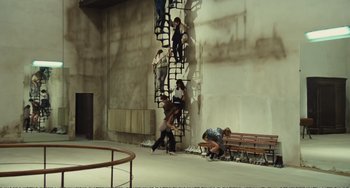 Movie still from “City of Women” (1980), directed by Federico Fellini – A group of young people climbing up a set of stairs; Extreme Wide shot, High angle